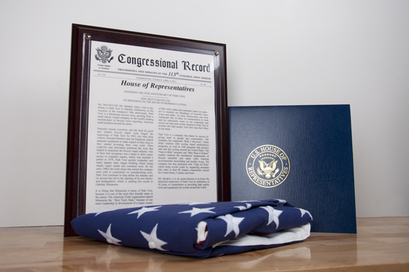Framed congressional record, folded American flag and US House of Representatives folder