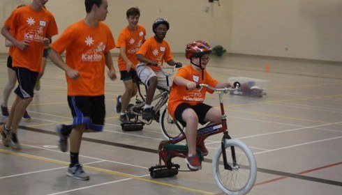 I can shine; Winners of community grant riding bike in indoor gym