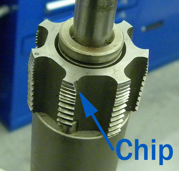 Arrow pointing to chips on the very first edge of the tap