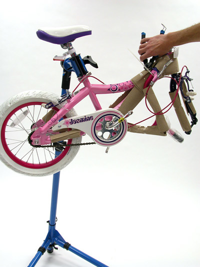 Small pink bicycle on Park Tool repair stand