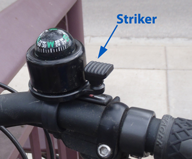 Blue arrow pointing to a bell striker