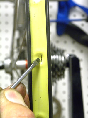 This crack is at the pocket of the modular Mavic MA40 and sharp end of a spoke awaits the fragile inner tube