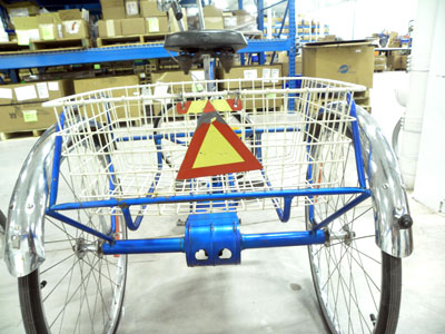 "slow moving vehicle" sign on the back of the basket