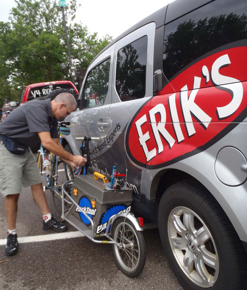 Brad Cole of Erik's Bike Shop working on support caravan