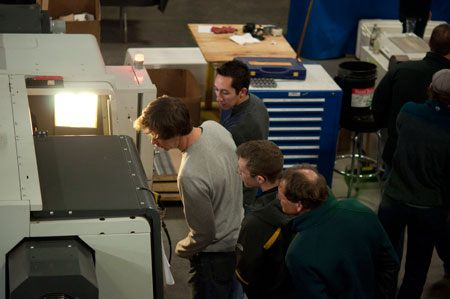 Small grouVisitors inspect our new CNC lathep on Park Tool tour looking into large machine