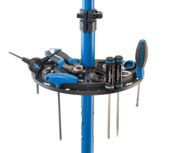 The half circle Park Tool 104 Work Tray attached to a Park Tool Repair Stand with tools placed on it, click to enlarge