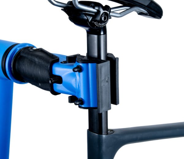 The Park Tool 1971 Clamp Adapter for D-Shaped Seatposts mounted in a PCS-10.3 repair stand clamp, holding a D-shaped seatpost on a road bike., click to enlarge