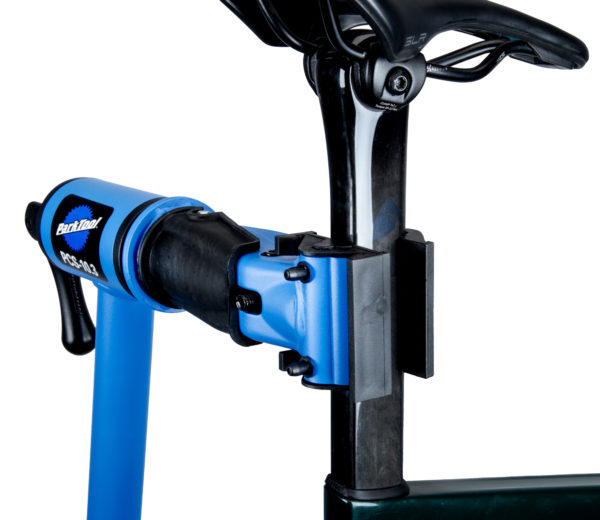 The Park Tool 1971 Clamp Adapter for D-Shaped Seatposts mounted in a PCS-10.3 repair stand clamp, holding a D-shaped seatpost on a road bike., click to enlarge