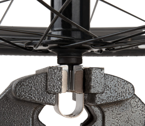 The Park Tool AV-1 Axle Vise holding a bicycle hub axle in a bench vise, click to enlarge