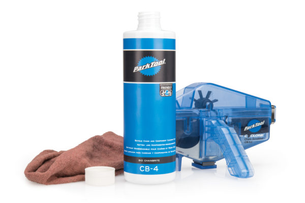 Bottle of Park Tool CB-4 Bio ChainBrite with a rag and CM-5.3 Cyclone™ Chain Scrubber, click to enlarge