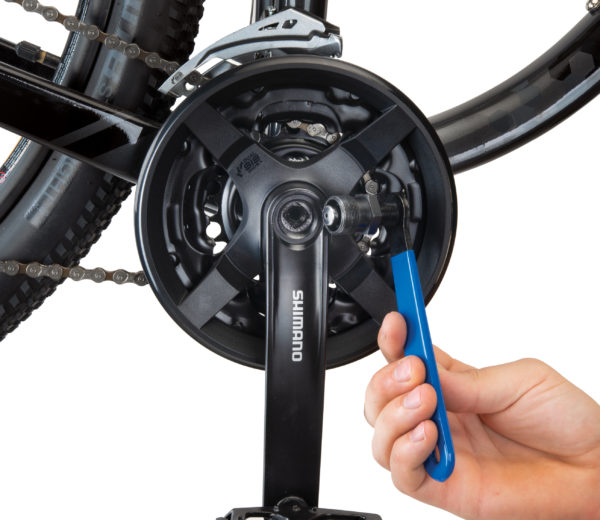 Park Tool CCP-22 Crank Puller next to square spindle fitting on bike crankset, click to enlarge