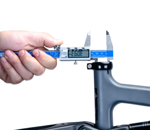 The Park Tool DC-2 Digital Caliper measuring the inner diameter of a seat post clamp on a gray bike frame., click to enlarge