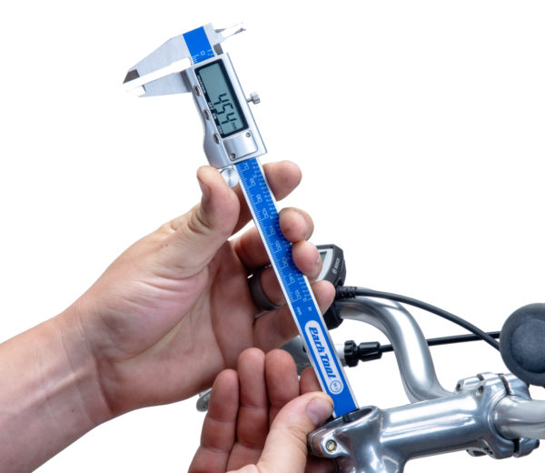 DC-2 Digital Caliper measuring the distance between the top of a stem and the top of a fork tube, click to enlarge
