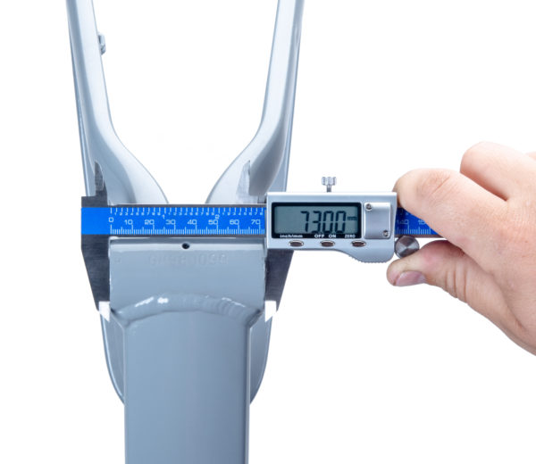 The Park Tool DC-2 Digital Caliper measuring a bottom bracket shell on a gray alloy mountain bike frame., click to enlarge