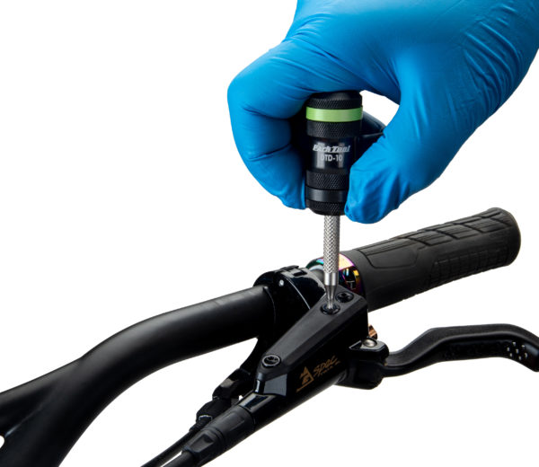 The DTD-10 T10 Precision Torx®-Compatible Driver loosening a bleed port on flat bar brake levers, click to enlarge