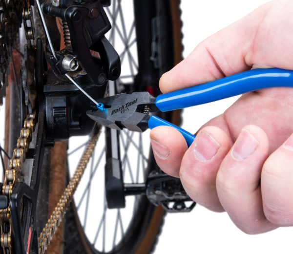 The Park Tool EP-1 End Cap Crimping Pliers crimping a cable ferrule on a rear MTB derailleur, click to enlarge