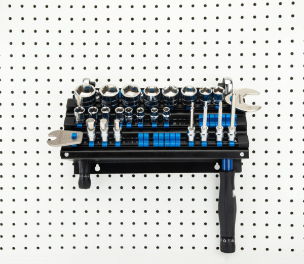 The Park Tool JH-3 Wall-Mounted Socket, Bit & Torque Tool Organizer mounted to white pegboard holding sockets, click to enlarge
