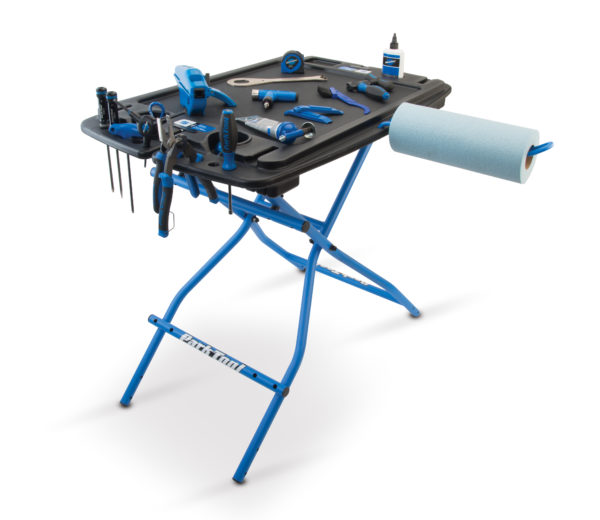 The Park Tool PB-1 Portable Workbench with tools displayed on top and the PTH-1 Paper Towel Holder attached, click to enlarge