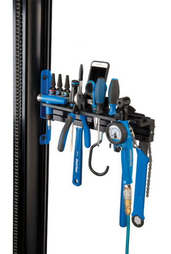 The Park Tool PRS-33TT Deluxe Tool and Work Tray full of tools and a phone attached to repair stand, click to enlarge