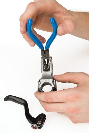 The Park Tool RP-1 0.9mm Internal Retaining Ring Pliers removing snap ring from brake lever body, click to enlarge