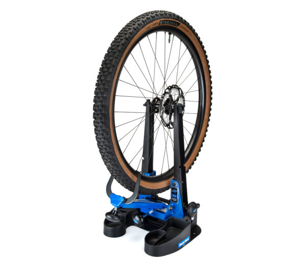 The TS-2.3 Professional Wheel Truing Stand mounted on a TSB-2.2 tilting base holding a MTB wheel with tire, click to enlarge