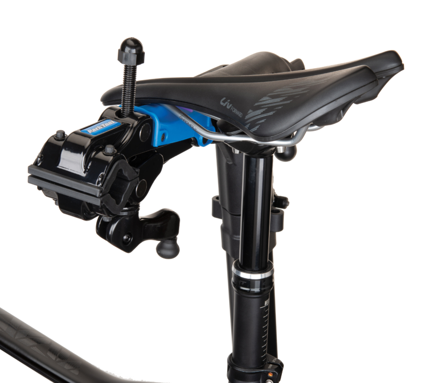 The Park Tool 100-25D Professional Micro-Adjust Clamp attached to stand with saddle resting on saddle cradle, enlarged