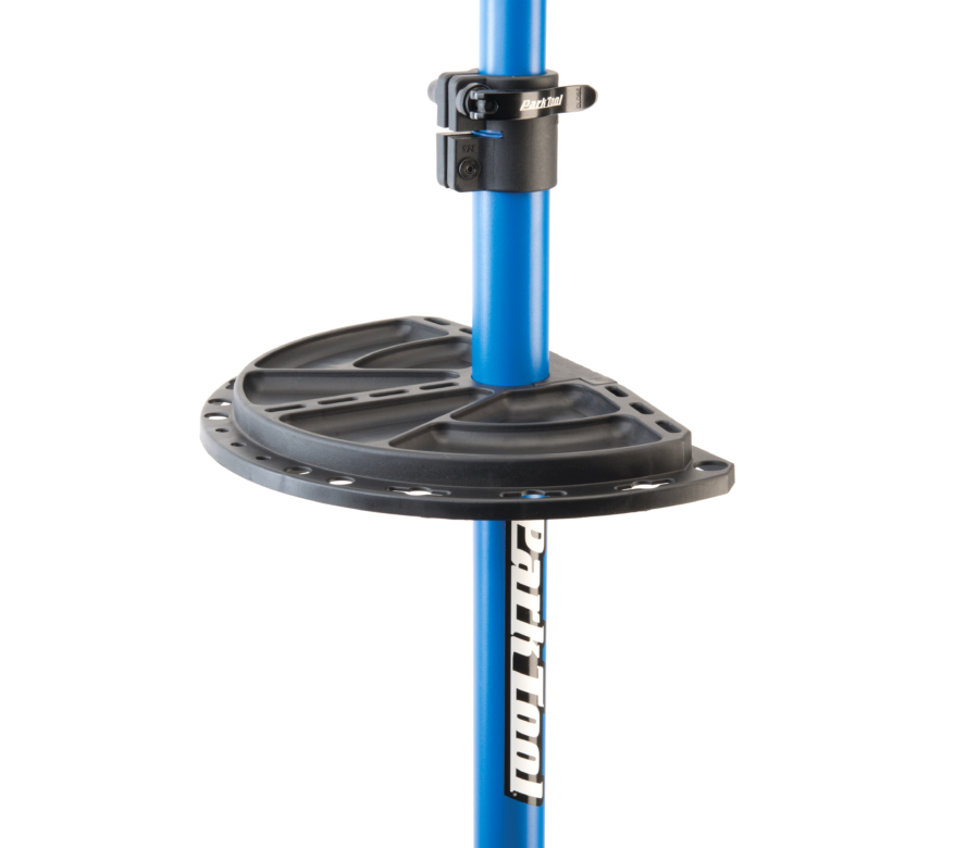The half circle Park Tool 104 Work Tray attached to a Park Tool Repair Stand, enlarged