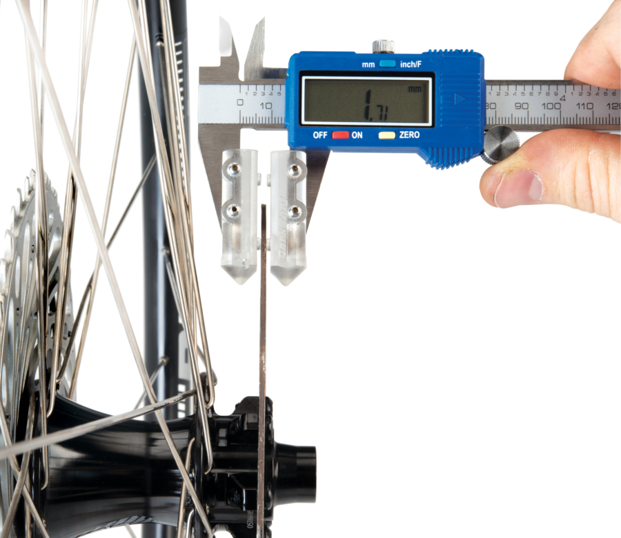 The Park Tool DCA-1 Digital Caliper Accessory measuring thickness of the braking surface on a disc brake, enlarged
