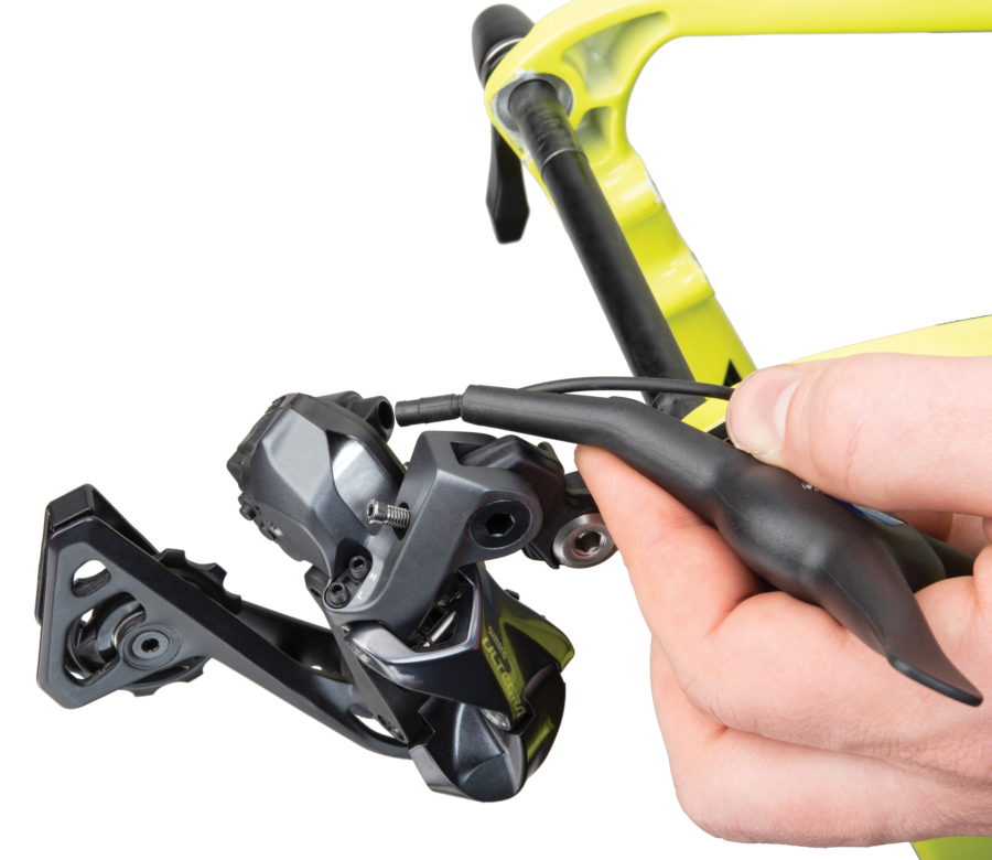 The Park Tool EWS-1 Bicycle Electronic Shift Tool hooking E-TUBE® up to Shimano® rear derailleur, enlarged