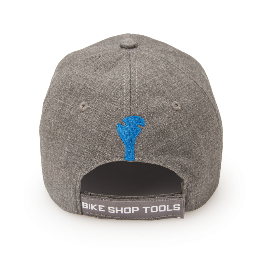 Back of Gray Park Tool hat with blue wrench and "bike shop tools" on adjustment strap, enlarged