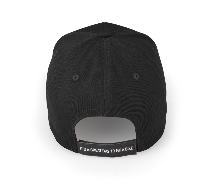 Back of a black baseball hat with "Its a great day to fix a bike" on adjustment strap, enlarged
