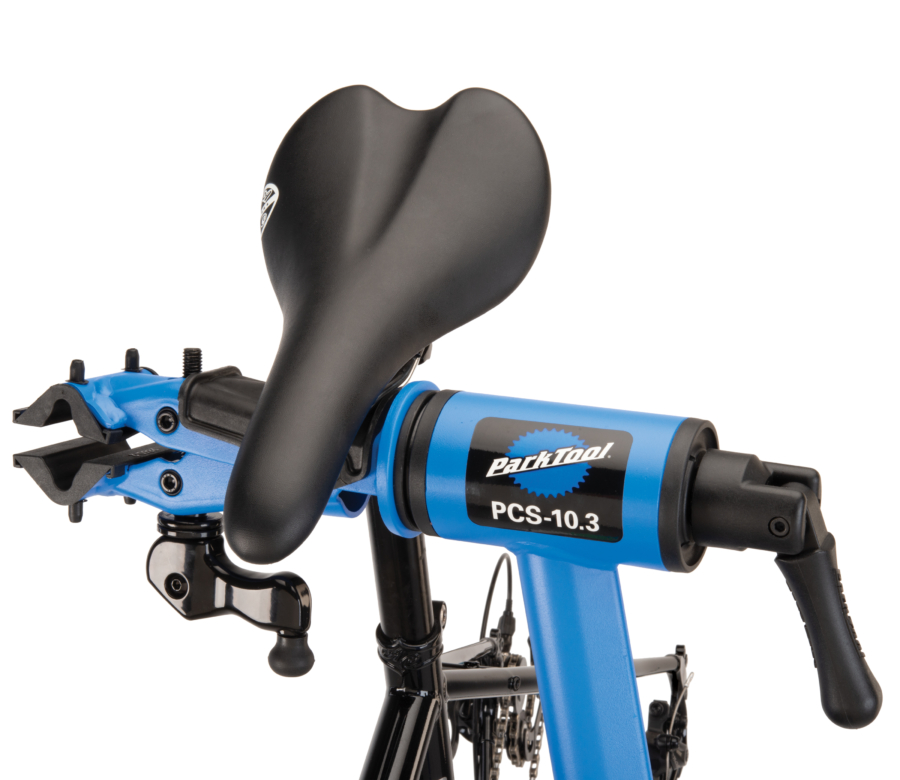 The Park Tool PCS-10.3 Deluxe Home Mechanic Repair Stand resting a bike seat on the clamp saddle, enlarged