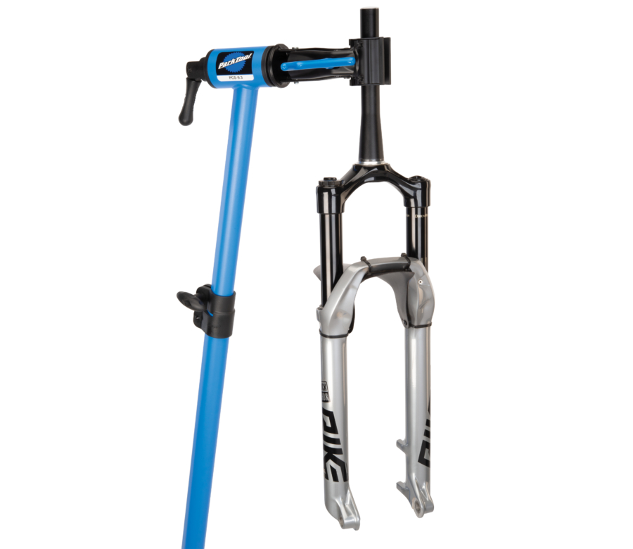 The Park Tool PCS-9.3 Home Mechanic Repair Stand holding a MTB suspension fork, enlarged