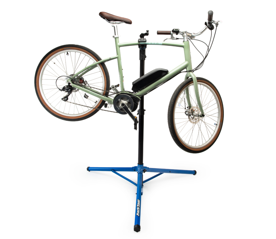 The Park Tool PRS-26 Team Issue Repair Stand holding a green e-bike, enlarged