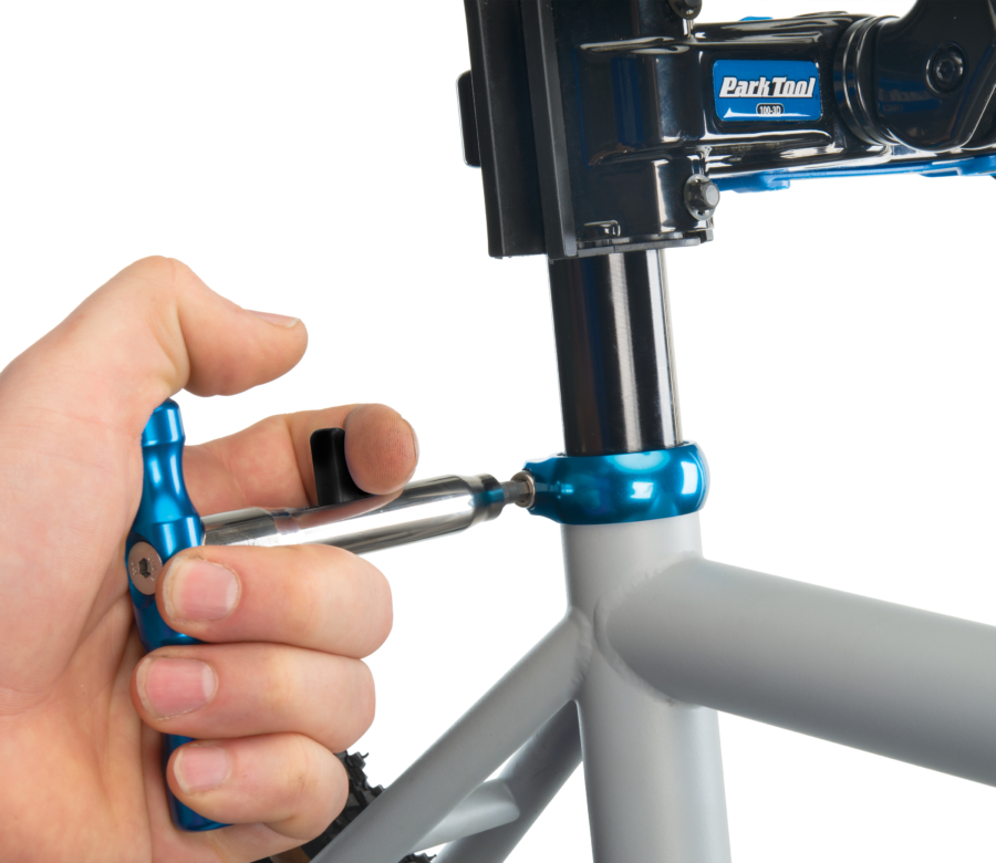 The Park Tool QTH-1 Quick Change Bit Driver Set handle driving a seat post collar pinch bolt, enlarged