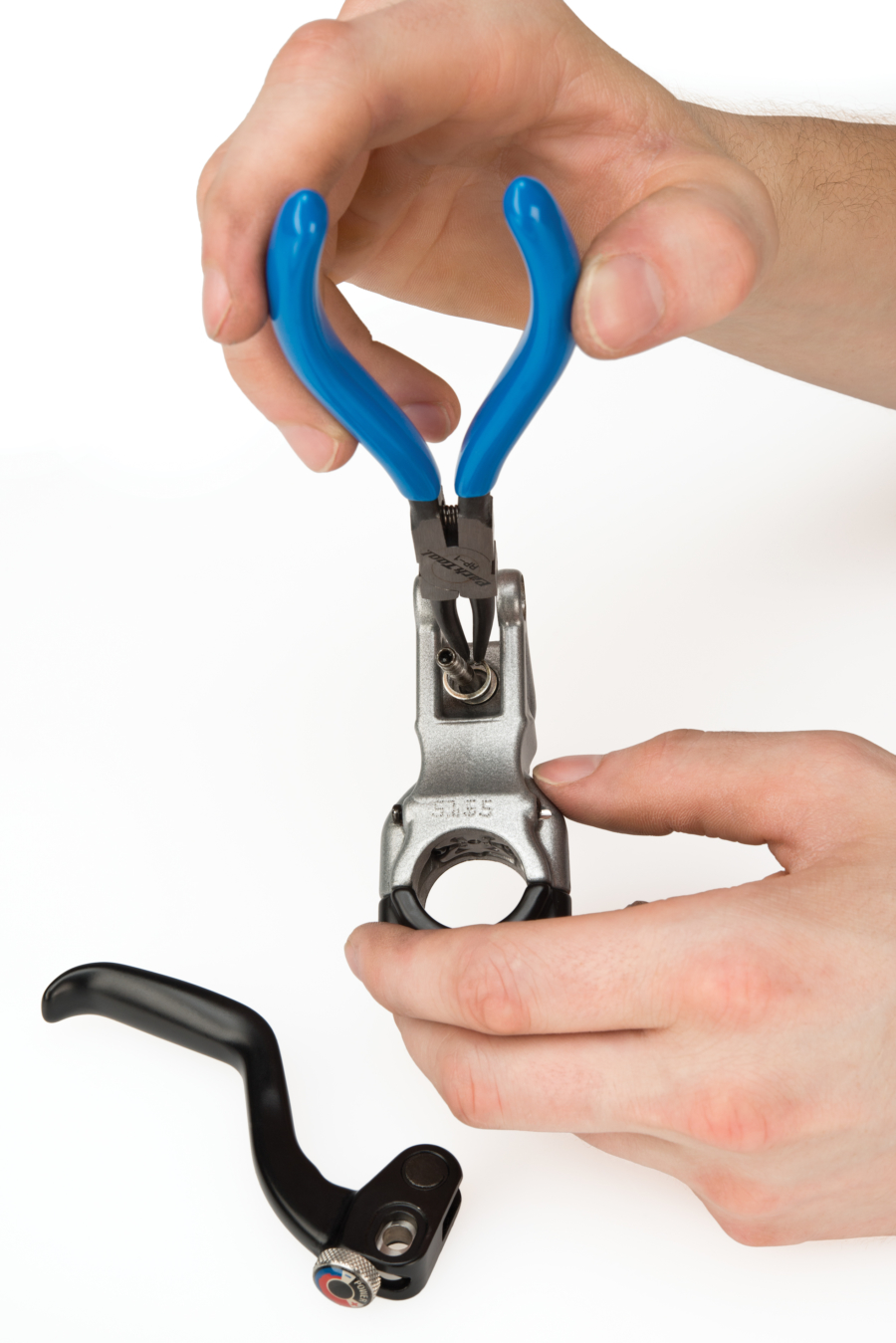 The Park Tool RP-1 0.9mm Internal Retaining Ring Pliers removing snap ring from brake lever body, enlarged