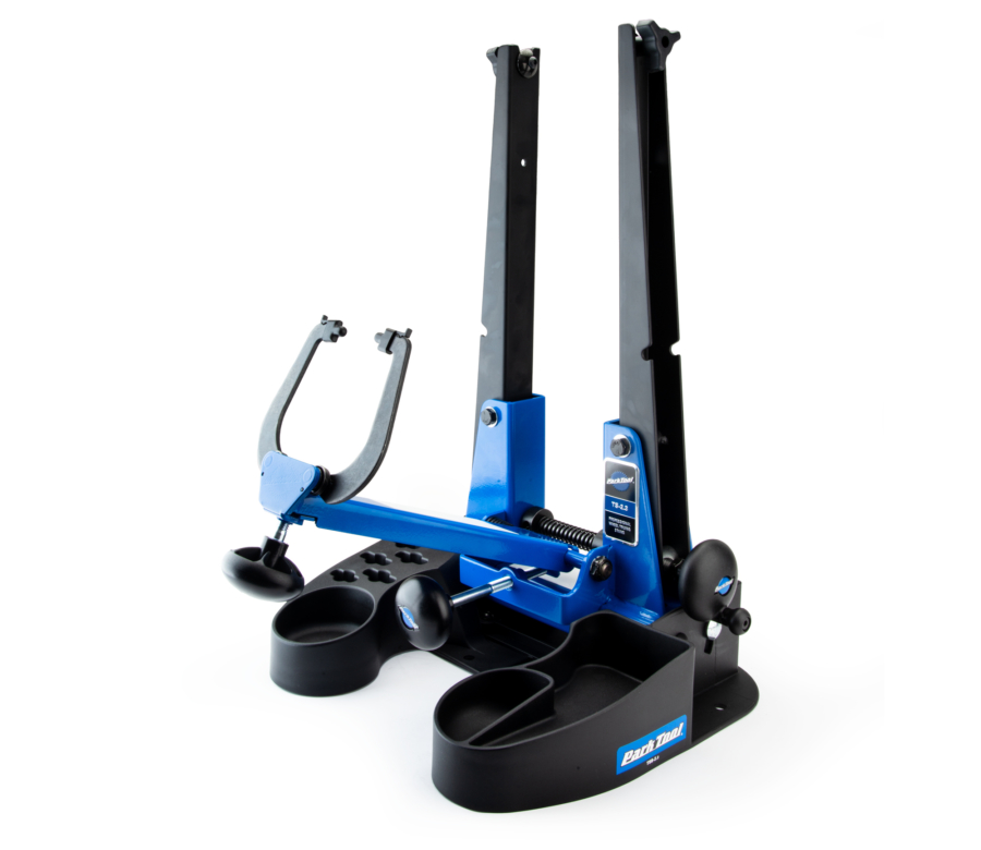 The TS-2.3 Professional Wheel Truing Stand mounted on a tilting base with thru axle adapters in the uprights, enlarged