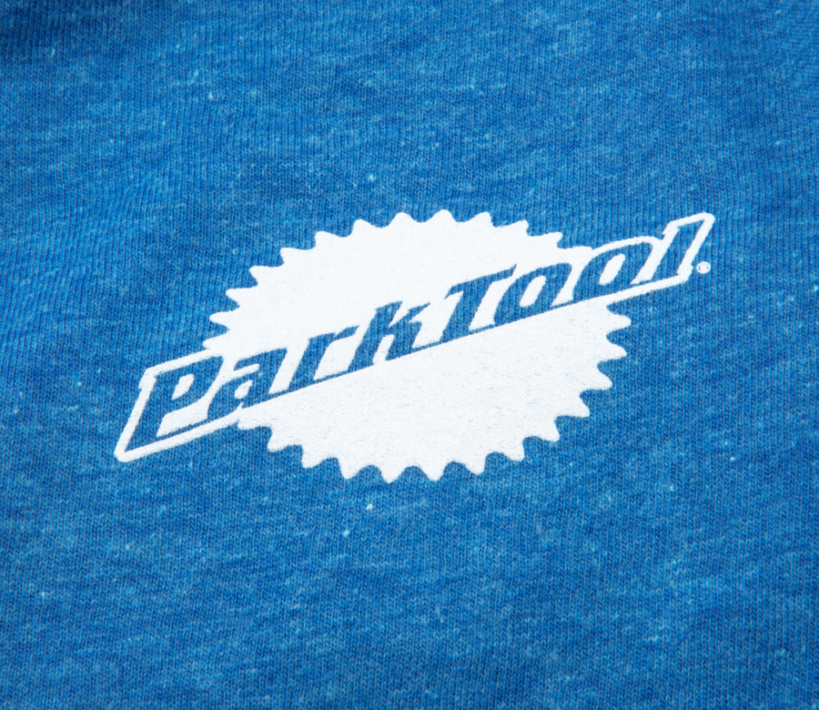 Closeup of screen printed Park Tool logo on the front of the TSM-1 Metal to the Pedal T-Shirt, enlarged