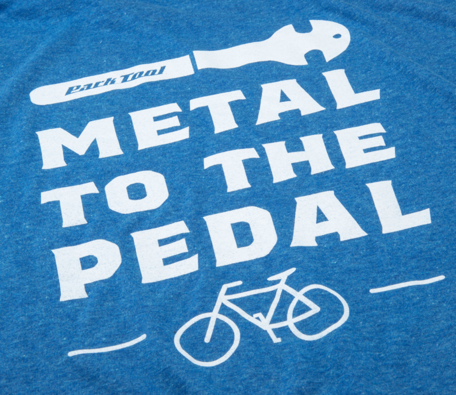 Closeup of screen printed Metal to the Pedal graphic on the back of the TSM-1 Metal to the Pedal T-Shirt, enlarged