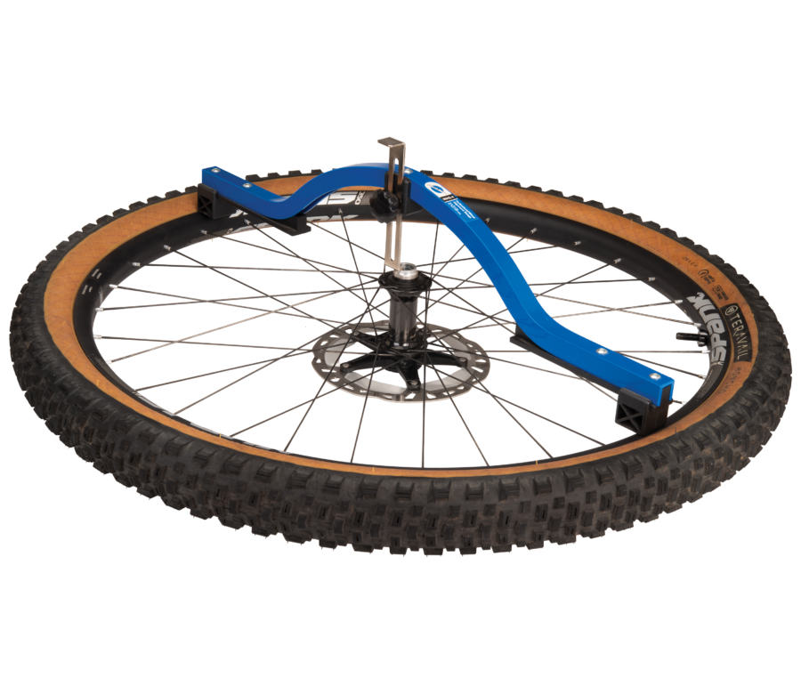 The Park Tool WAG-4 Professional Wheel Alignment Gauge measuring dish on front disc brake mountain bike wheel, enlarged