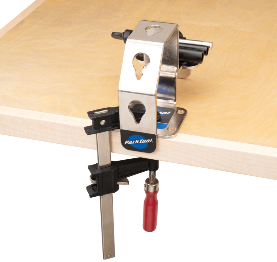 Park Tool WH-1 Wheel Holder temporarily installed on workbench with C-clamp, enlarged