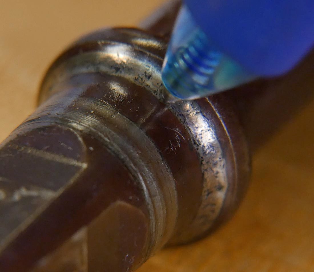 Closeup of ball point pen tip rolling over bearing surface of bottom bracket spindle