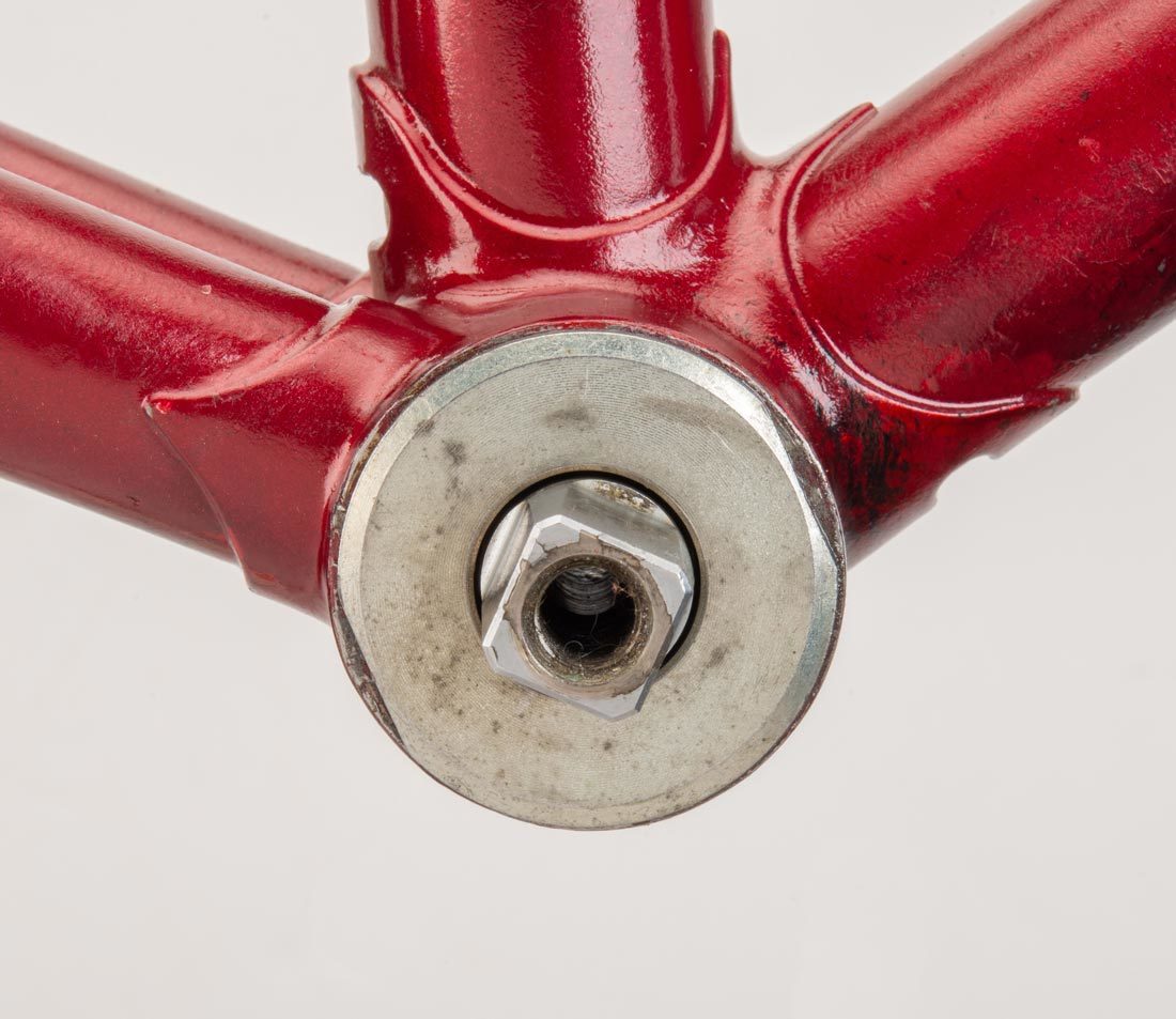 Bottom bracket cup with two wrench flats on outer perimeter, installed in bottom bracket shell