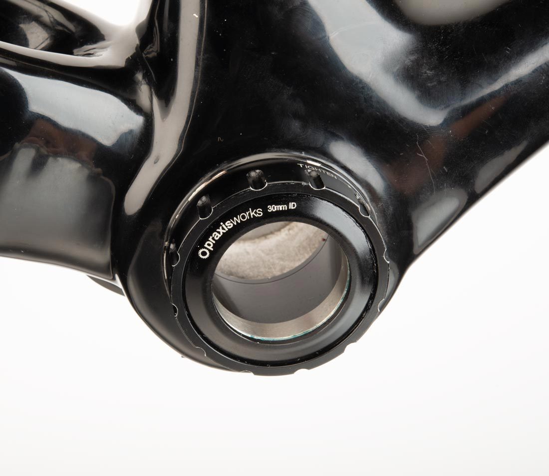 Threaded bottom bracket cup with 12 external notches, installed in bottom bracket shell of carbon fiber frame