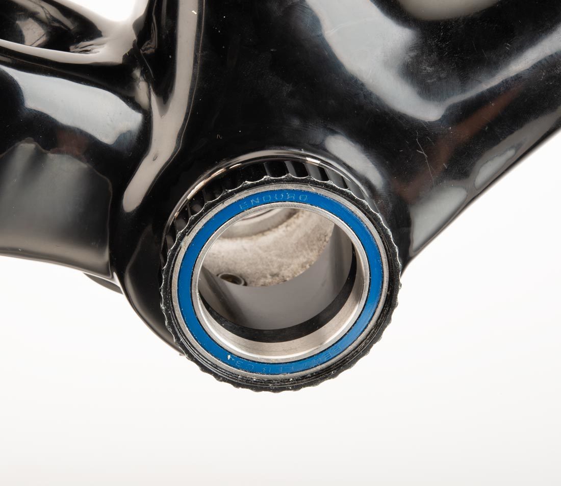 Threaded bottom bracket cup with 36 external notches, installed in bottom bracket shell on carbon fiber frame