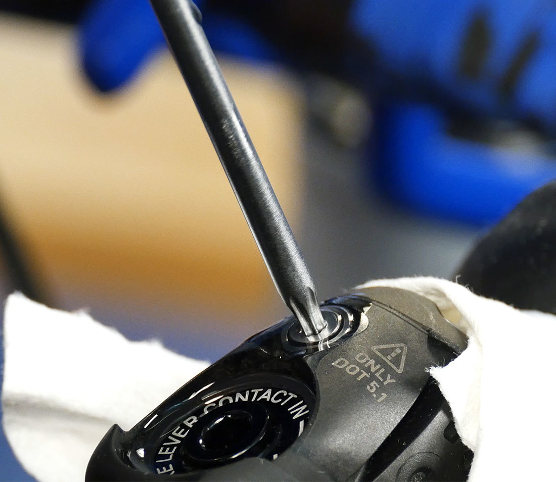 Bleed port screw on brake lever being tightened by a Torx® compatible wrench