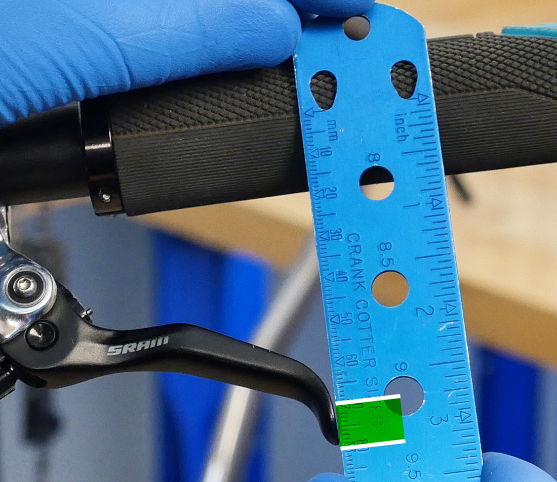 SBC-1 being held across center of handlebar and tip of brake lever to measure distance