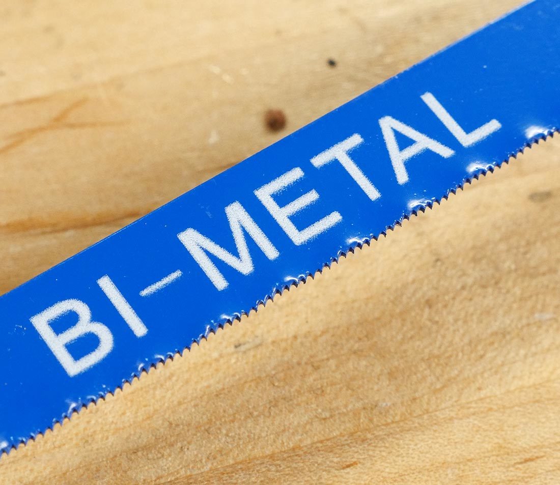 A traditional metal blade is sufficient for most metal bars