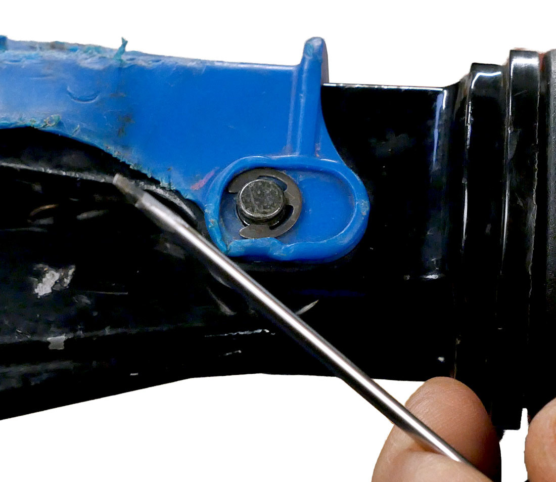 Use a small flat-blade screwdriver to remove the C-clip