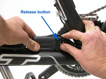 Figure 24. Pull quick-release lever at battery bracket and push release button to remove battery